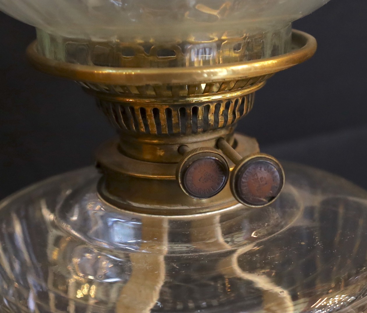 A late Victorian/Edwardian Corinthian column brass oil lamp, with cut glass reservoir, J.R.Roberts mechanism, fluted glass globe and flue, height overall 83cm
